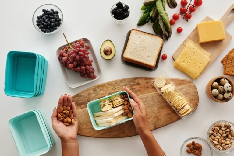 A vibrant flat lay of preparing a healthy snack with fresh ingredients like fruits, nuts, and cheese.